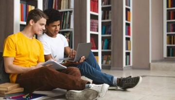 Two students researching how to get more financial aid