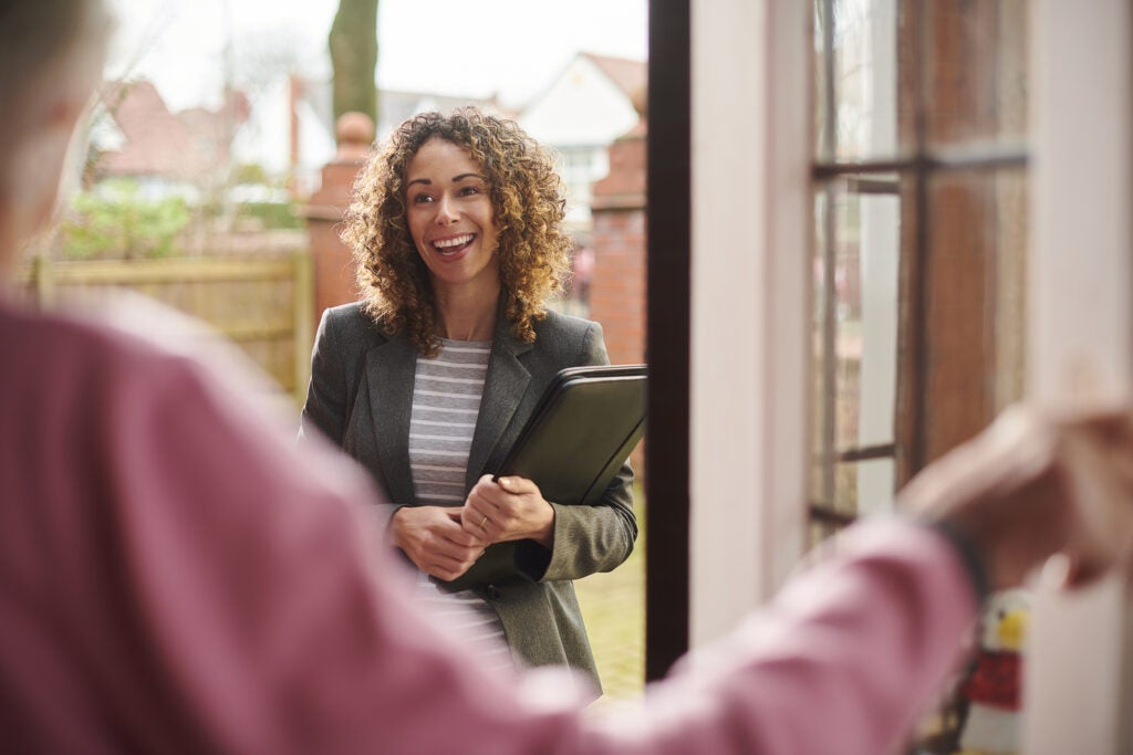 Social worker making a drop-by visit with elderly woman