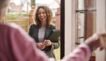 Social worker making a drop-by visit with elderly woman