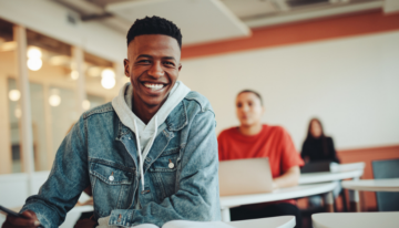 Male high school student learning ways to save money for college.