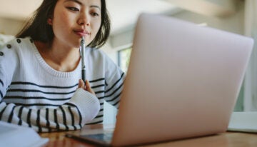 Asian female checks student loan balance.