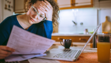 Woman looking over her unemployment income while filling out the FAFSA.