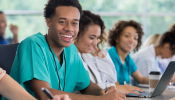 Black male premed student sitting in class.