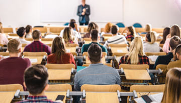 Professor speaking to a room of college students.