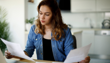 Woman looking over paperwork.