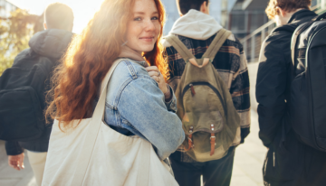 Young girl walking to class on her college campus.