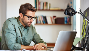 Young man researching on computer.