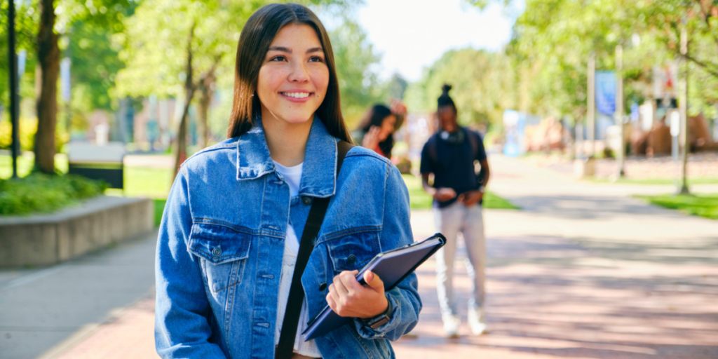 Young female college student standing on campus.