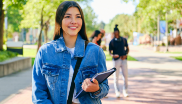 Young female college student standing on campus.