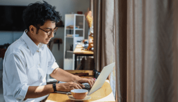 Young Asian man working on his computer.