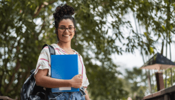 Young female college student standing on campus.