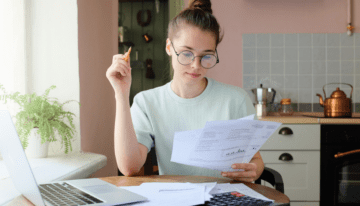 Young female student looking over tax paperwork.