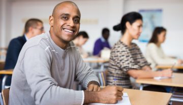 Older adult college student sitting in class after going back to school.