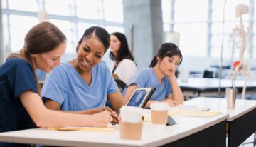 Female medical students sitting in class after looking at scholarships for female medical students.