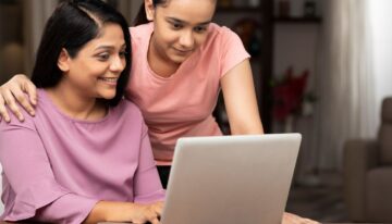 Mom and daughter looking up how to pay off parent plus loans faster.