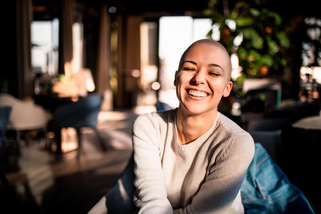Portrait of a smiling girl with short laughing with her eyes closed