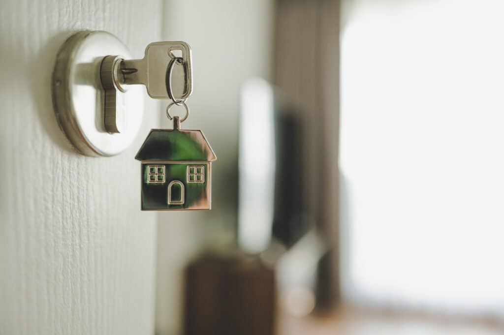 key in door that shows how student loans effect the housing market