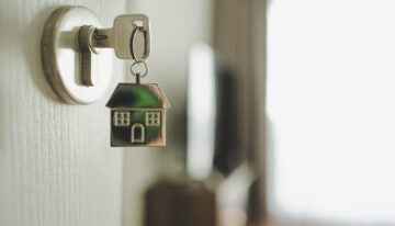 key in door that shows how student loans effect the housing market