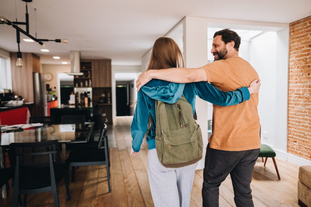 Father and daughter talking while walking at home