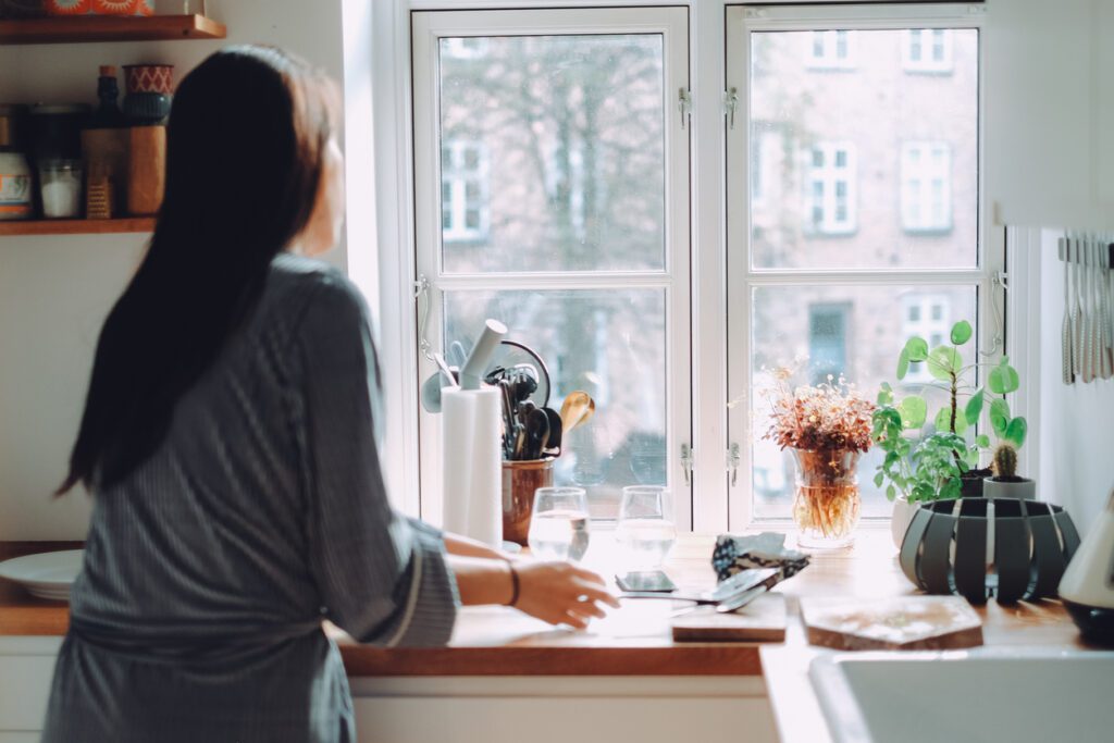 Busy young woman preparing breakfast in the kitchen