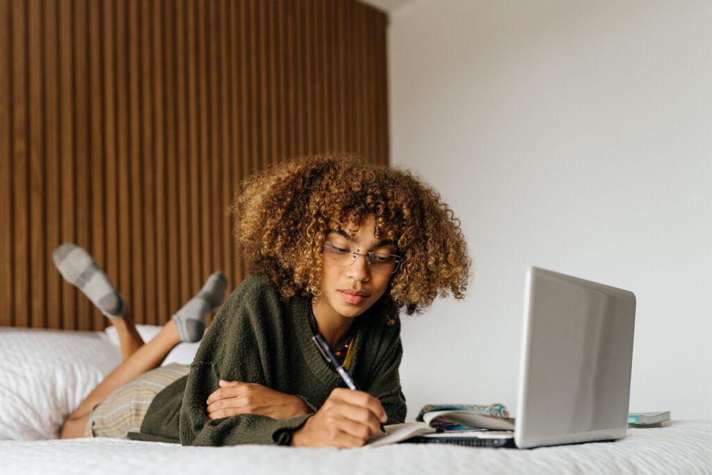 college student studying in bed