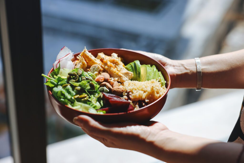 Holding a bowl of a healthy salad