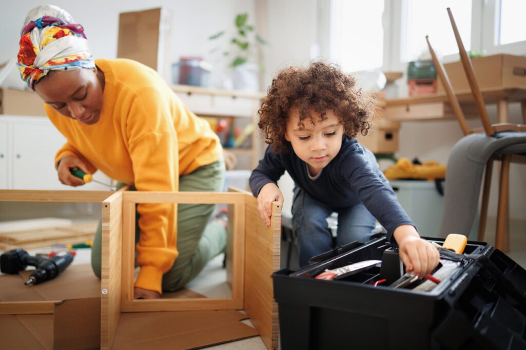 Mother and her son are assembling furniture at home