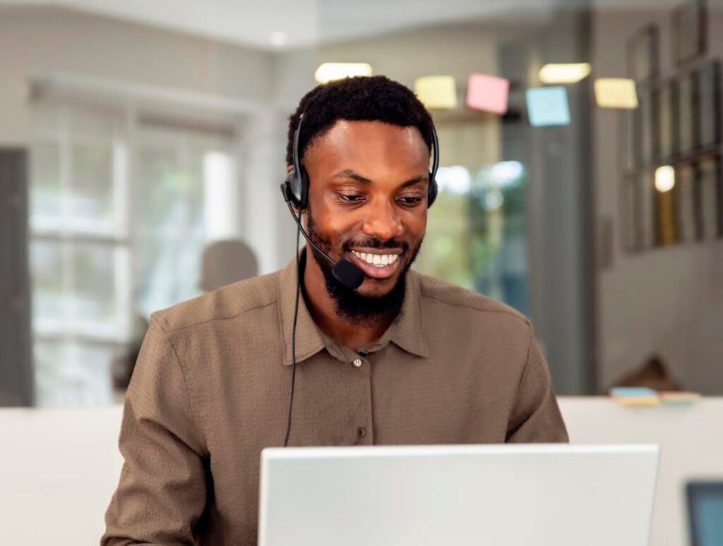 Confident smiling black Man customer service working in modern office