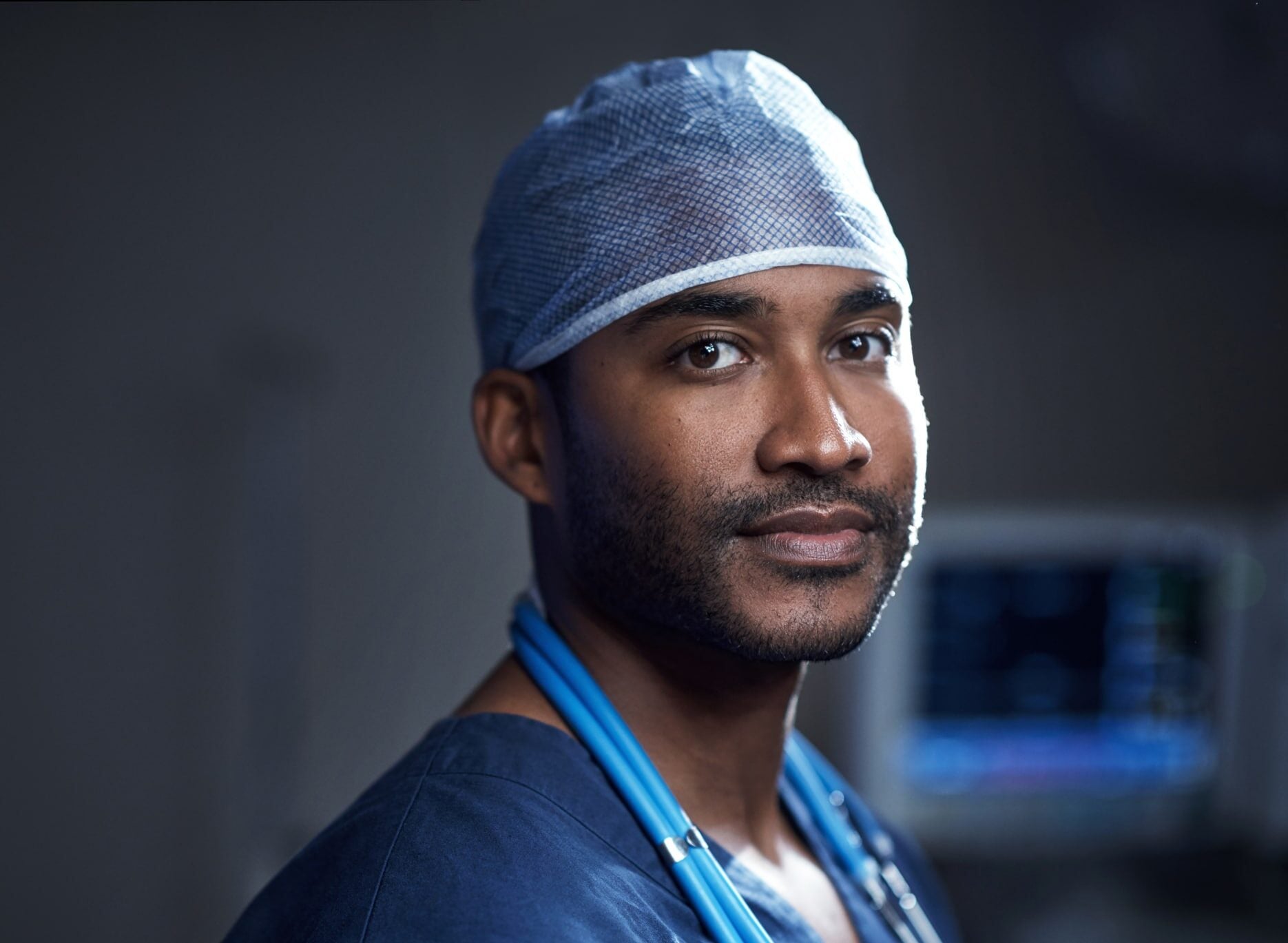 Portrait of a confident young surgeon standing in an operating room