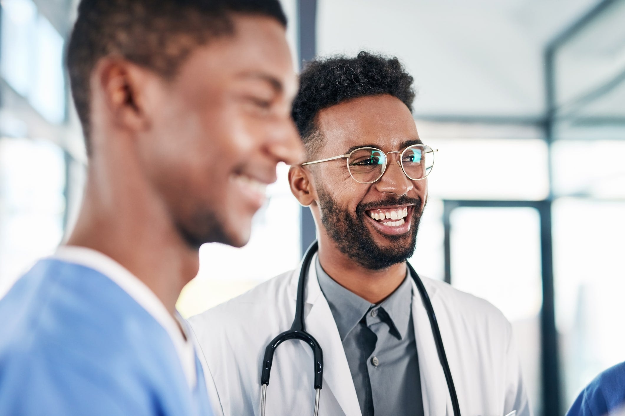 Shot of a young doctor having a discussion with his colleagues in a hospital