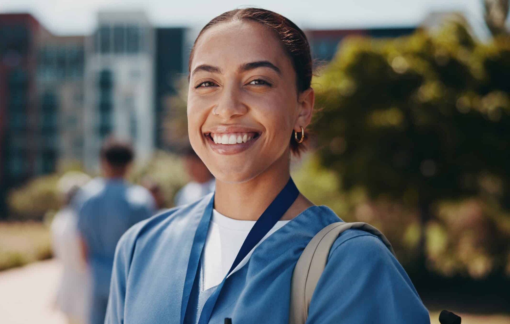 Portrait, doctor or woman in medicine outdoor for health training program, healthcare study or hospital residency. Medical school, student or smile with learning backpack on campus for nursing career